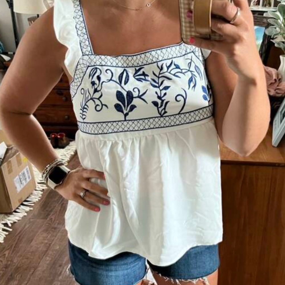 White with blue embroidered blouse